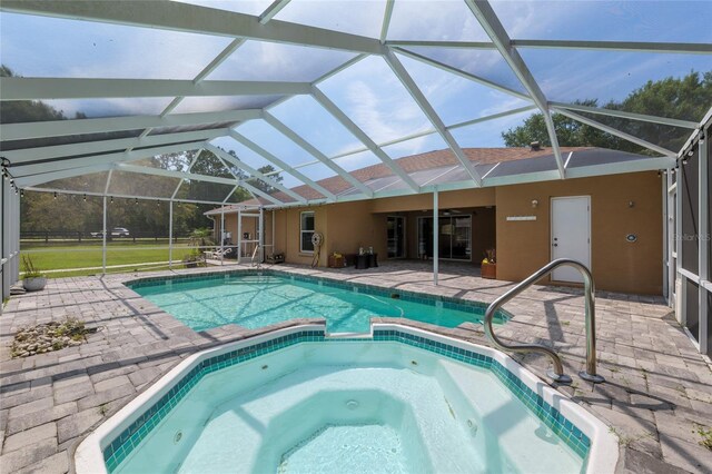 12495 SW 66th St, Ocala, FL 34481 - view of swimming pool with a patio, a pool with connected hot tub, and glass enclosure