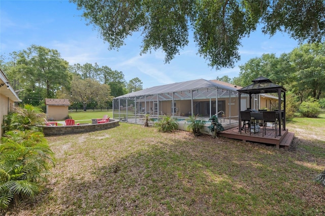 12495 SW 66th St, Ocala, FL 34481 - view of grassy yard featuring an outdoor pool, glass enclosure, a gazebo, and a deck