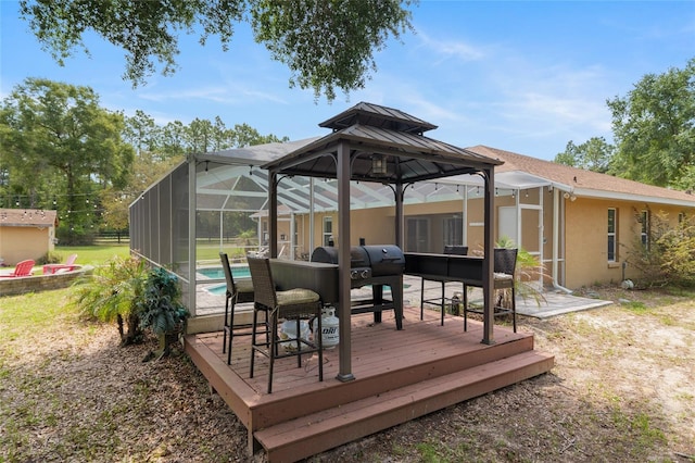 12495 SW 66th St, Ocala, FL 34481 - wooden deck with a gazebo, an outdoor pool, and glass enclosure