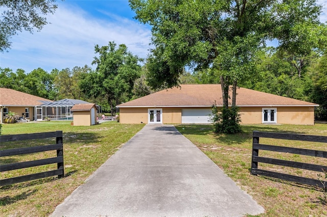 12495 SW 66th St, Ocala, FL 34481 - single story home with french doors, asphalt driveway, and stucco siding