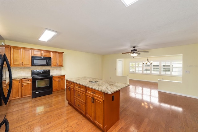 8745 SW 92nd St Unit B, Ocala, FL 34481 - kitchen featuring black appliances, brown cabinetry, ceiling fan, backsplash, and light wood-type flooring