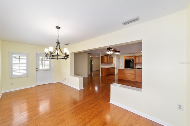 8745 SW 92nd St Unit B, Ocala, FL 34481 - unfurnished dining area with a chandelier, light wood finished floors, baseboards, and ceiling fan