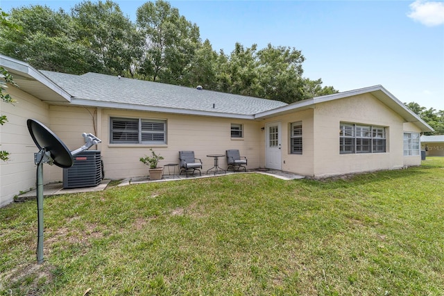 8745 SW 92nd St Unit B, Ocala, FL 34481 - rear view of property featuring a patio area, a lawn, and roof with shingles