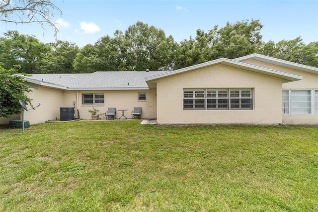 8745 SW 92nd St Unit B, Ocala, FL 34481 - rear view of property with a yard, central AC, concrete block siding, and a patio area