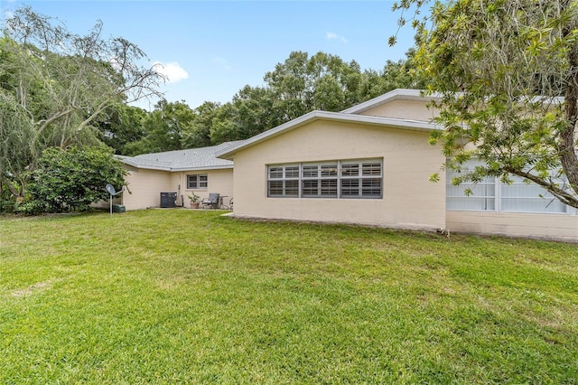 8745 SW 92nd St Unit B, Ocala, FL 34481 - rear view of property featuring a yard