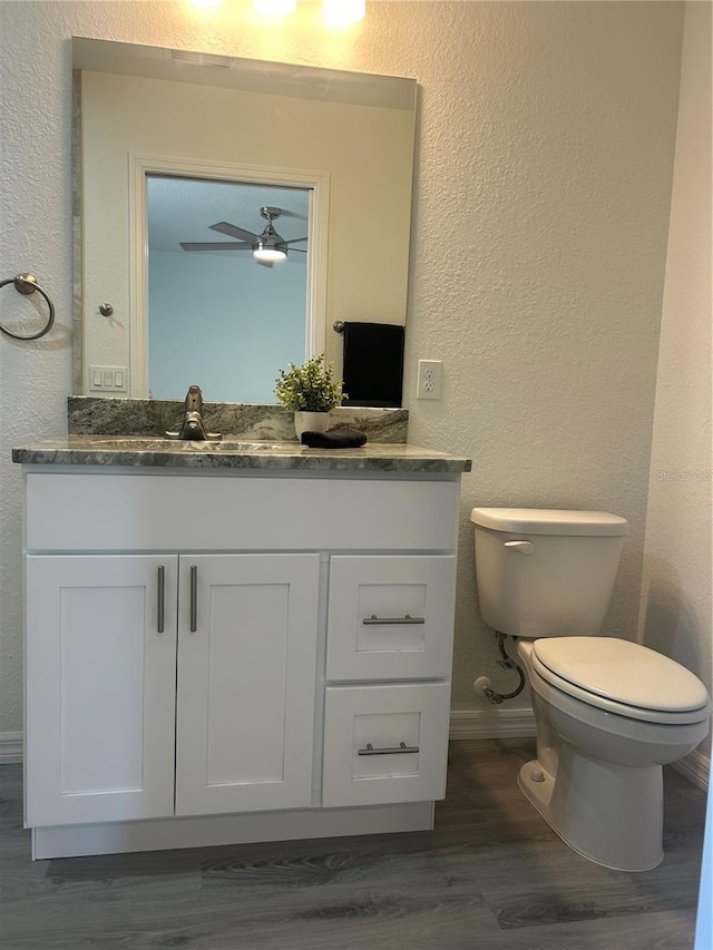 960 NW Redwood Dr, Dunnellon, FL 34431 - half bathroom featuring vanity, baseboards, wood finished floors, toilet, and a textured wall