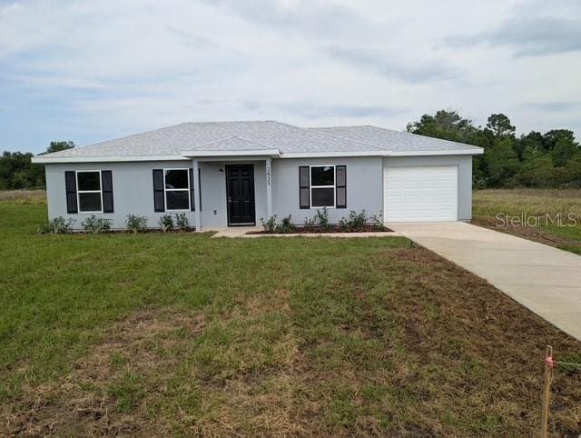 2825 SW 147th Ct, Ocala, FL 34481 - ranch-style home with an attached garage, concrete driveway, a front yard, and stucco siding