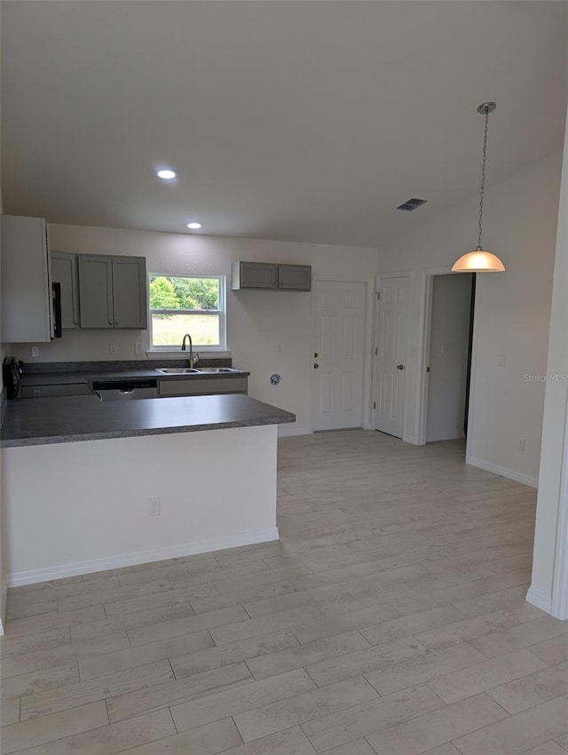 2825 SW 147th Ct, Ocala, FL 34481 - kitchen with gray cabinetry, a sink, dark countertops, a peninsula, and recessed lighting
