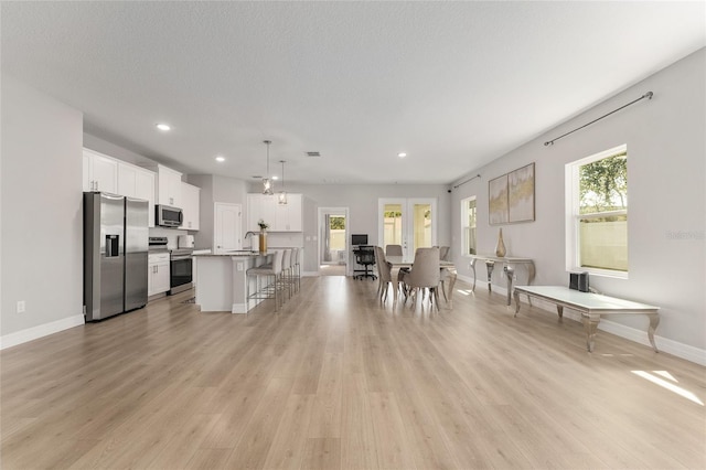14055 SW 30th Terrace Rd, Ocala, FL 34473 - kitchen featuring stainless steel appliances, a breakfast bar, a sink, white cabinets, and recessed lighting
