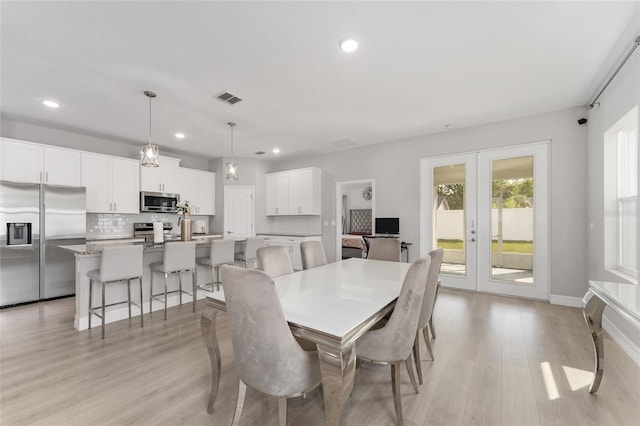 14055 SW 30th Terrace Rd, Ocala, FL 34473 - dining area with french doors, light wood-style floors, recessed lighting, and baseboards