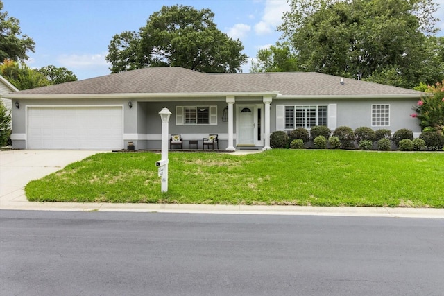 14481 SW 112th Cir, Dunnellon, FL 34432 - single story home with covered porch, an attached garage, driveway, stucco siding, and a front lawn