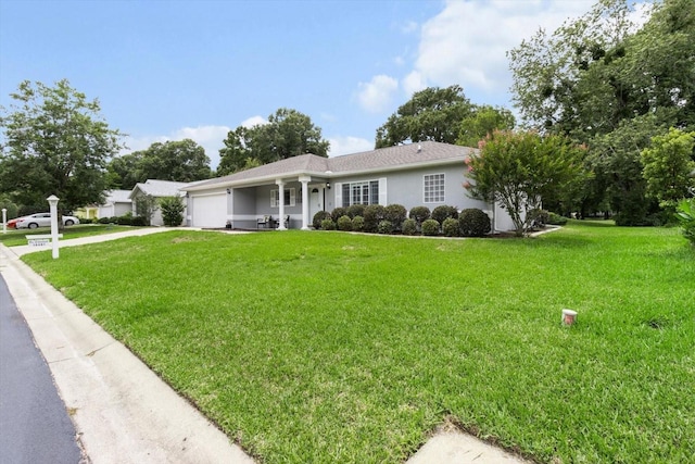 14481 SW 112th Cir, Dunnellon, FL 34432 - ranch-style house featuring a garage, a front yard, concrete driveway, and stucco siding