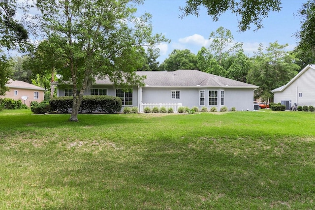 14481 SW 112th Cir, Dunnellon, FL 34432 - rear view of house featuring a lawn, cooling unit, and stucco siding