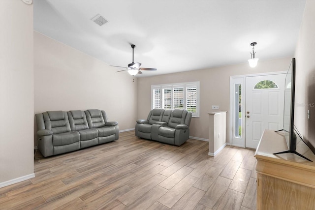 14481 SW 112th Cir, Dunnellon, FL 34432 - living room with light wood-style floors, a ceiling fan, and baseboards