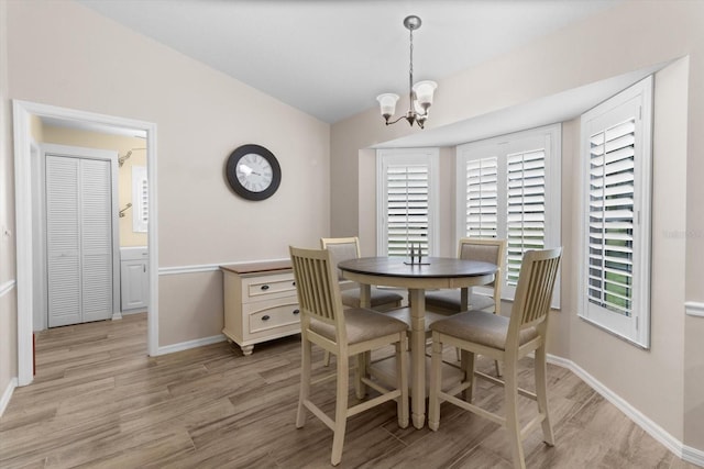 14481 SW 112th Cir, Dunnellon, FL 34432 - dining area featuring a chandelier, light wood-style flooring, and baseboards