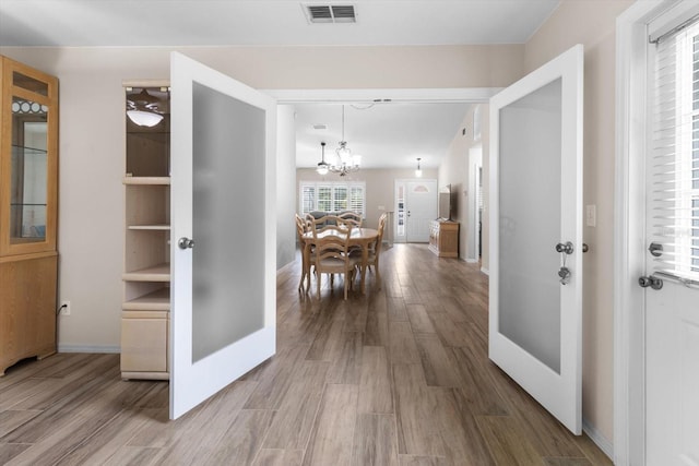 14481 SW 112th Cir, Dunnellon, FL 34432 - corridor with a chandelier, baseboards, and wood finished floors