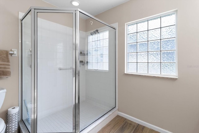 14481 SW 112th Cir, Dunnellon, FL 34432 - full bathroom with toilet, healthy amount of natural light, wood finished floors, and a shower stall
