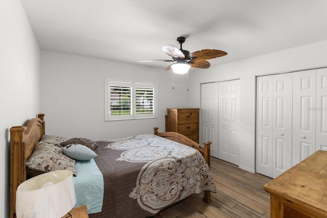 14481 SW 112th Cir, Dunnellon, FL 34432 - bedroom featuring two closets, wood finished floors, and a ceiling fan