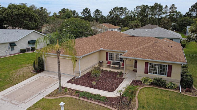 9891 SE 138th Loop, Summerfield, FL 34491 - view of front of property featuring a garage, driveway, stucco siding, a shingled roof, and a front yard