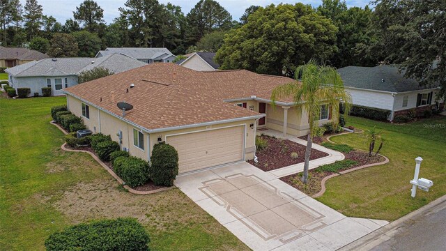 9891 SE 138th Loop, Summerfield, FL 34491 - view of front facade featuring driveway, an attached garage, a front lawn, and stucco siding