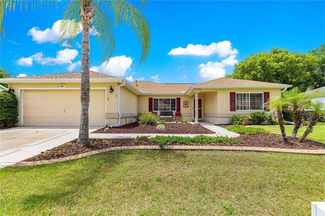 9891 SE 138th Loop, Summerfield, FL 34491 - ranch-style house featuring an attached garage, driveway, stucco siding, and a front lawn