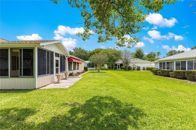 9891 SE 138th Loop, Summerfield, FL 34491 - view of grassy yard featuring a sunroom