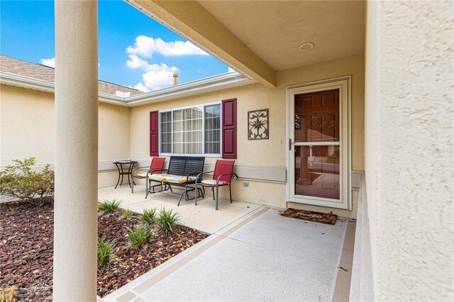 9891 SE 138th Loop, Summerfield, FL 34491 - view of exterior entry featuring stucco siding