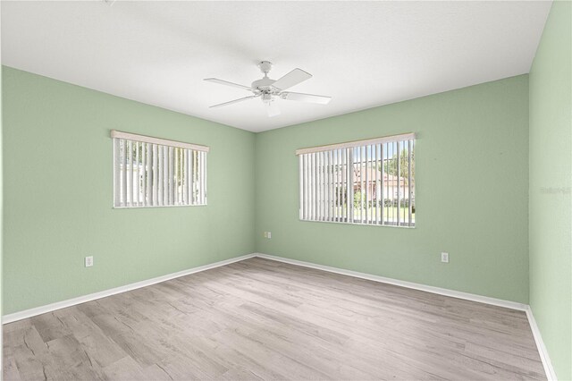 9891 SE 138th Loop, Summerfield, FL 34491 - empty room featuring a ceiling fan, wood finished floors, and baseboards