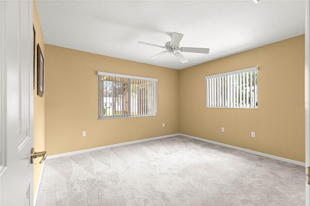 9891 SE 138th Loop, Summerfield, FL 34491 - carpeted spare room with healthy amount of natural light, ceiling fan, and baseboards