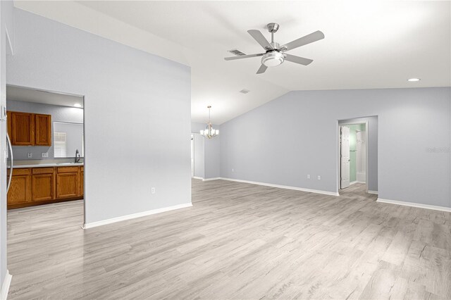 9891 SE 138th Loop, Summerfield, FL 34491 - unfurnished living room featuring ceiling fan, a chandelier, light wood-type flooring, baseboards, and lofted ceiling