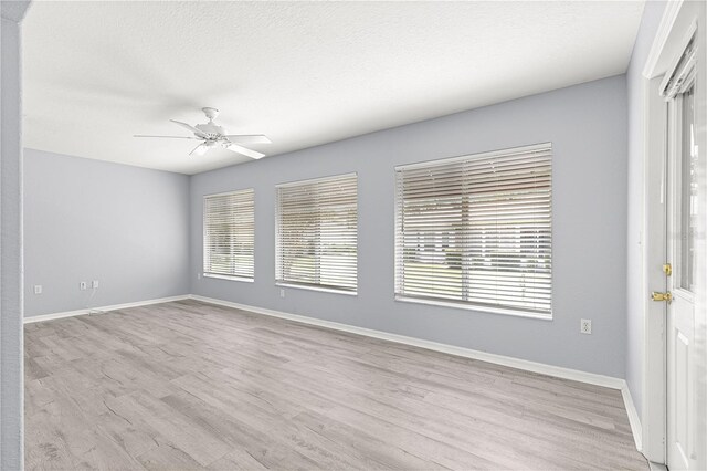 9891 SE 138th Loop, Summerfield, FL 34491 - unfurnished room with a ceiling fan, wood finished floors, and baseboards