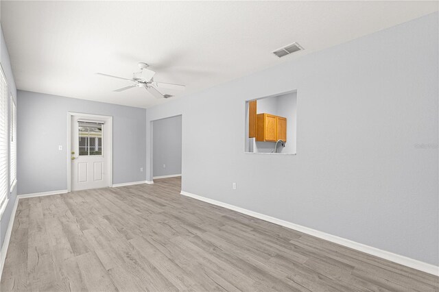 9891 SE 138th Loop, Summerfield, FL 34491 - unfurnished room featuring a ceiling fan, light wood finished floors, and baseboards