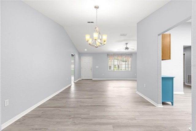 9891 SE 138th Loop, Summerfield, FL 34491 - unfurnished dining area featuring a chandelier, wood finished floors, a ceiling fan, baseboards, and vaulted ceiling