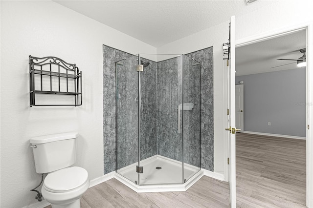 9891 SE 138th Loop, Summerfield, FL 34491 - bathroom with wood finished floors, a shower stall, toilet, a ceiling fan, and a textured ceiling