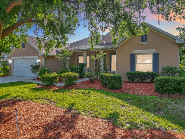 16 Ryewood Cir, Homosassa, FL 34446 - view of front of house with stucco siding, an attached garage, a yard, and driveway