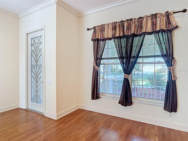 16 Ryewood Cir, Homosassa, FL 34446 - empty room featuring ornamental molding, wood finished floors, baseboards, and a textured ceiling