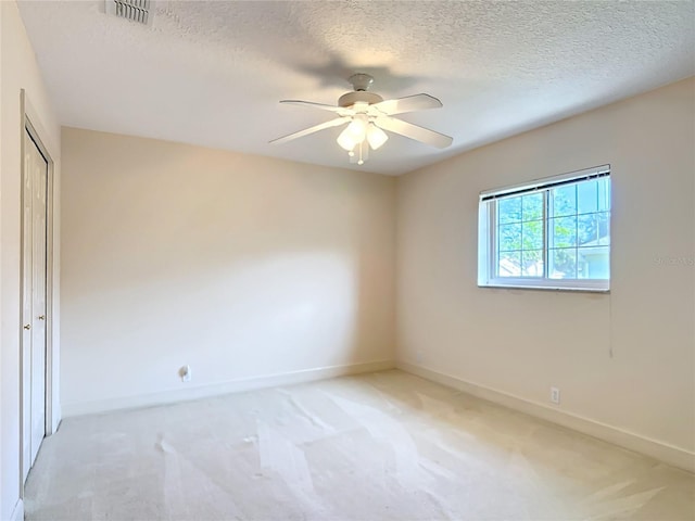 16 Ryewood Cir, Homosassa, FL 34446 - spare room featuring ceiling fan, light carpet, baseboards, and a textured ceiling