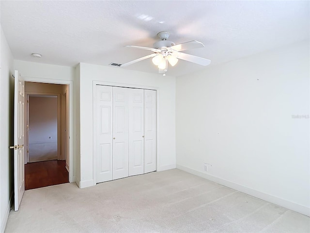 16 Ryewood Cir, Homosassa, FL 34446 - unfurnished bedroom with light carpet, a closet, baseboards, and a ceiling fan