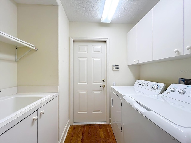 16 Ryewood Cir, Homosassa, FL 34446 - laundry room featuring cabinet space, washing machine and clothes dryer, dark wood finished floors, and a textured ceiling