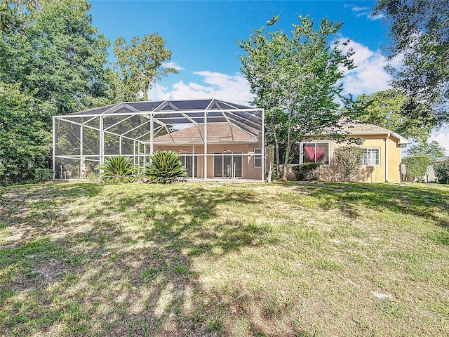 16 Ryewood Cir, Homosassa, FL 34446 - back of property featuring a lawn, stucco siding, and glass enclosure