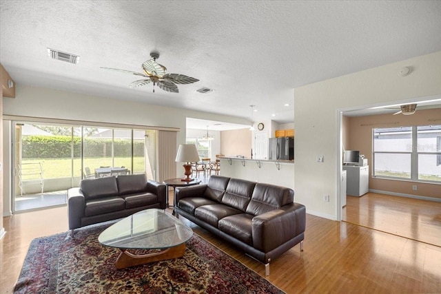 4225 SW 57th Ave, Ocala, FL 34474 - living area with a ceiling fan, light wood-type flooring, healthy amount of natural light, a textured ceiling, and baseboards