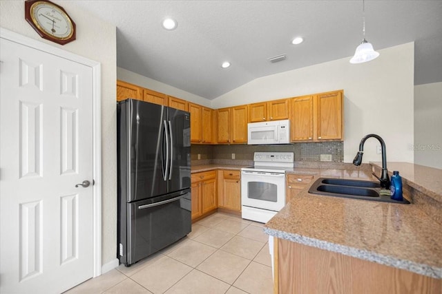 4225 SW 57th Ave, Ocala, FL 34474 - kitchen featuring white appliances, a sink, light tile patterned flooring, vaulted ceiling, and a peninsula