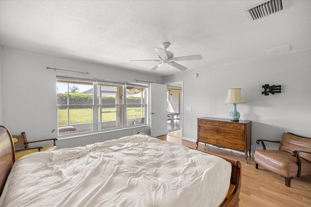 4225 SW 57th Ave, Ocala, FL 34474 - bedroom featuring a textured ceiling, light wood finished floors, and a ceiling fan