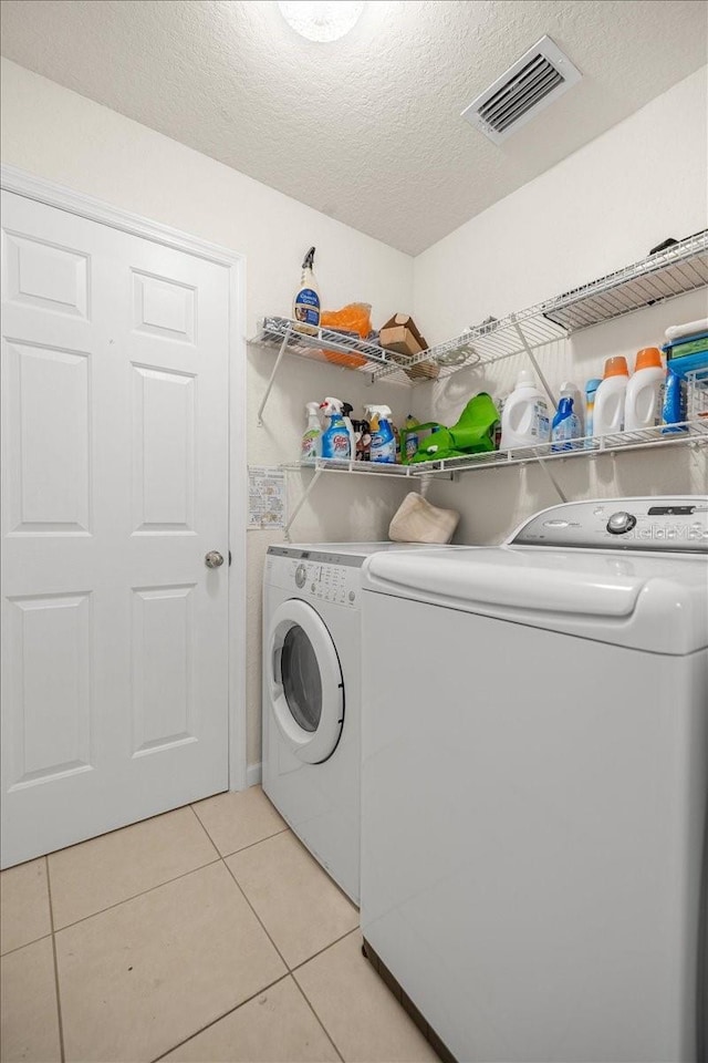 4225 SW 57th Ave, Ocala, FL 34474 - laundry area with independent washer and dryer, light tile patterned floors, and a textured ceiling