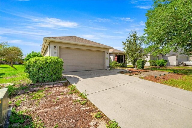 4225 SW 57th Ave, Ocala, FL 34474 - ranch-style home featuring stucco siding, an attached garage, and concrete driveway