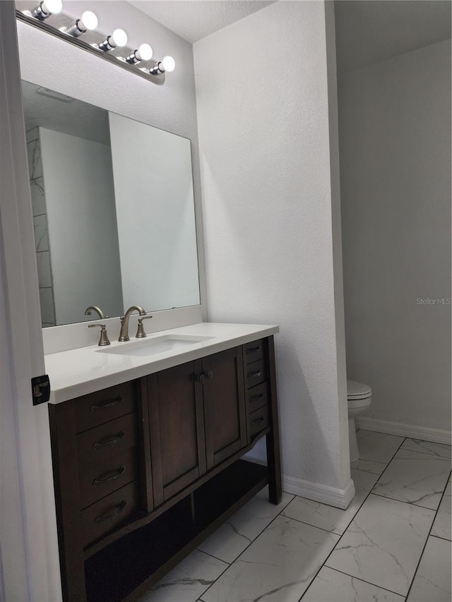 541 56th Ct, Ocala, FL 34482 - bathroom with marble look tile flooring, toilet, vanity, and baseboards