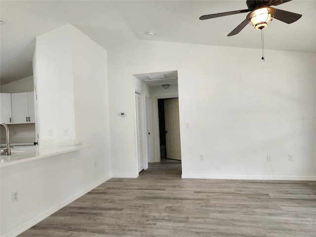 541 56th Ct, Ocala, FL 34482 - spare room with lofted ceiling, a sink, ceiling fan, light wood-style floors, and baseboards