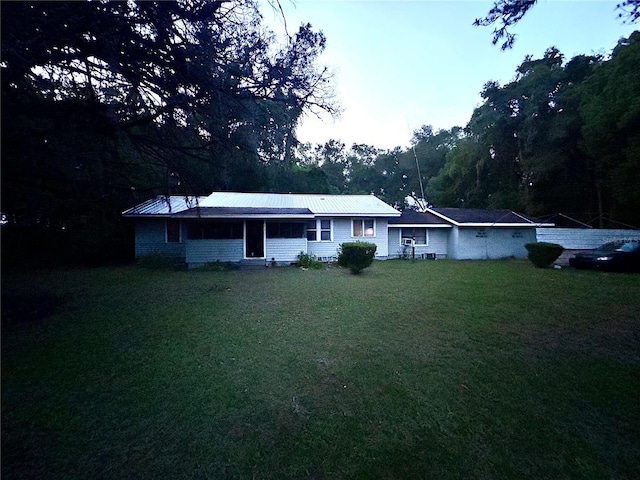 2409 NW 7th St, Ocala, FL 34475 - ranch-style home featuring a front yard and metal roof