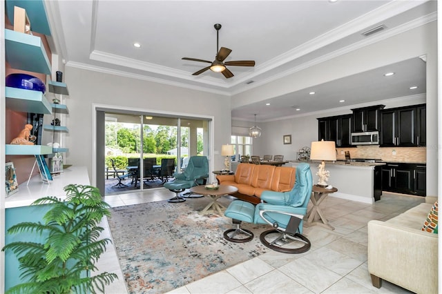7210 SW 179th Ct, Dunnellon, FL 34432 - living room featuring light tile patterned floors, ceiling fan, a tray ceiling, crown molding, and recessed lighting