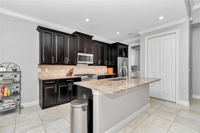 7210 SW 179th Ct, Dunnellon, FL 34432 - kitchen featuring stainless steel appliances, a sink, decorative backsplash, a center island with sink, and crown molding